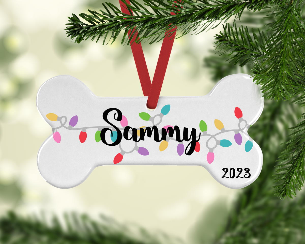 Dog-bone-shaped personalized ornament with looping holiday lights