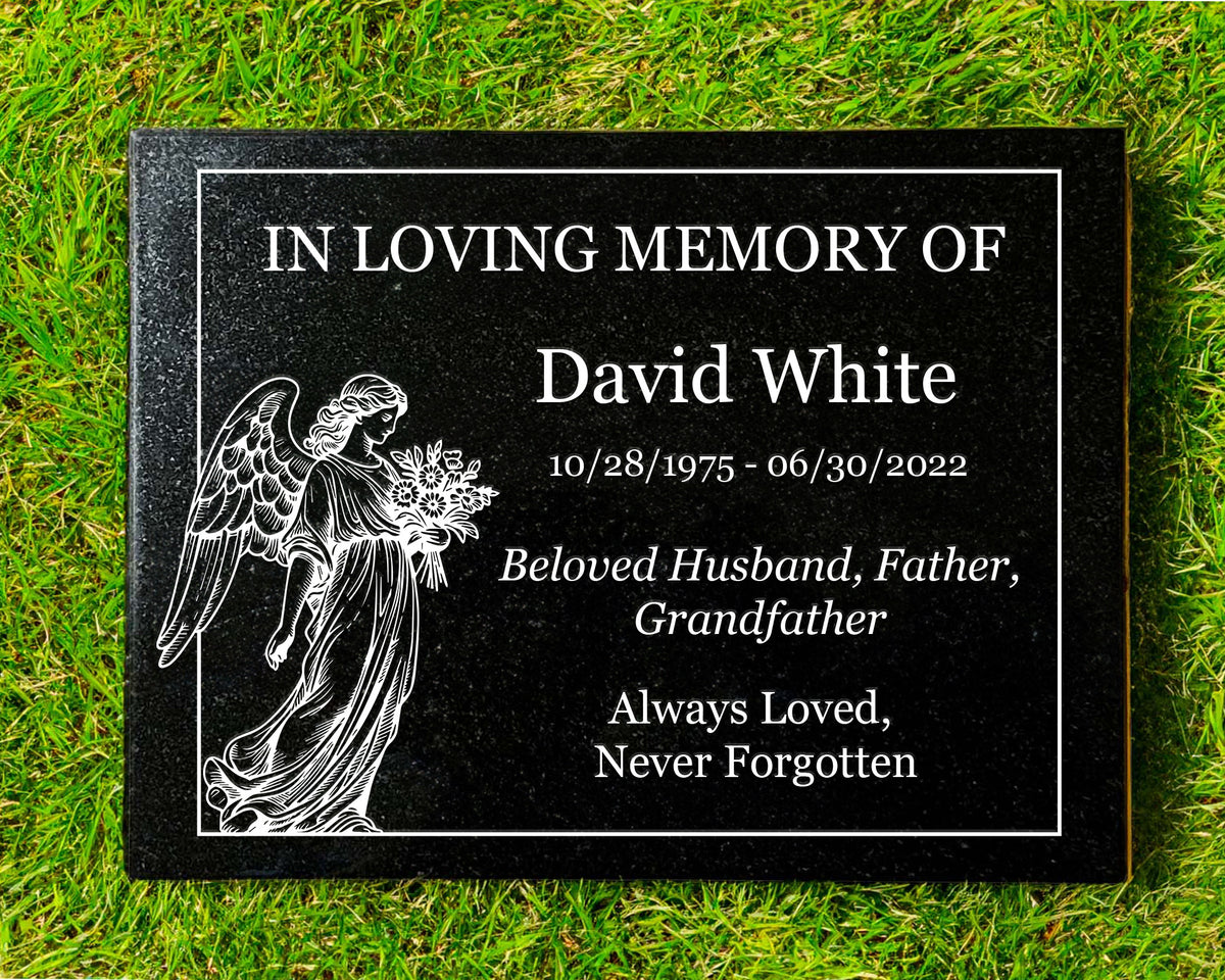 Black granite memorial plaque with an angel, flowers and In Loving Memory inscription