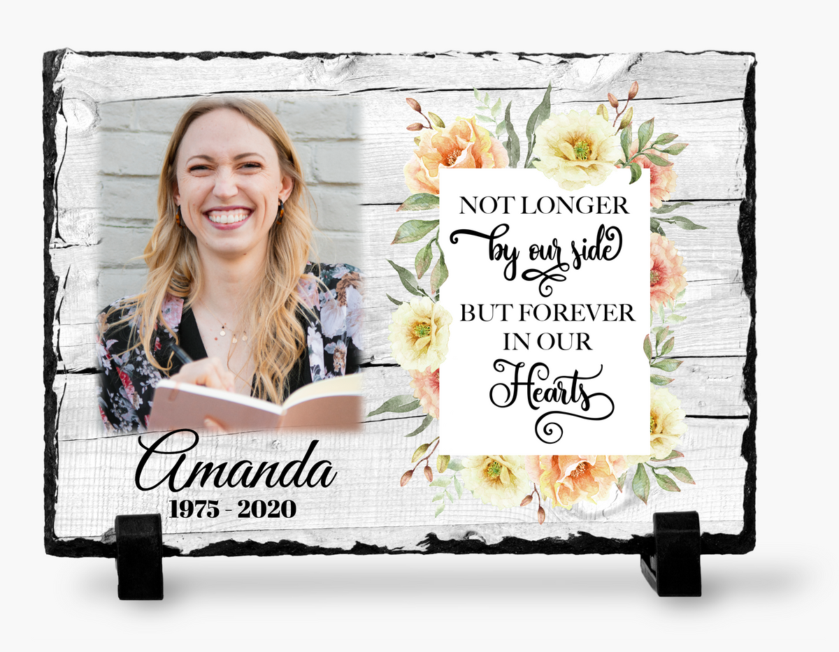 Floral memorial photo slate with a woman’s portrait, whitewashed-wood design, sample name and dates, and black stands