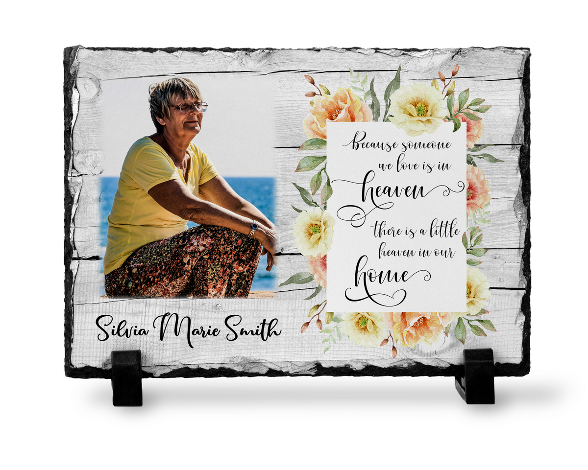 Front view of a floral memorial photo slate with a woman’s portrait, Heaven tribute, sample name and two black stands