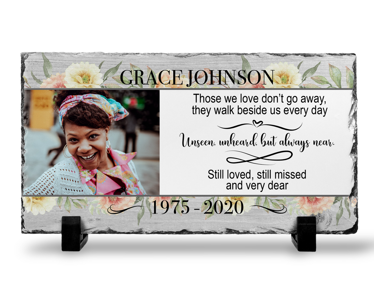 Memorial photo slate with a woman’s portrait, gray wood-look print, flowers and Those We Love Don’t Go Away tribute