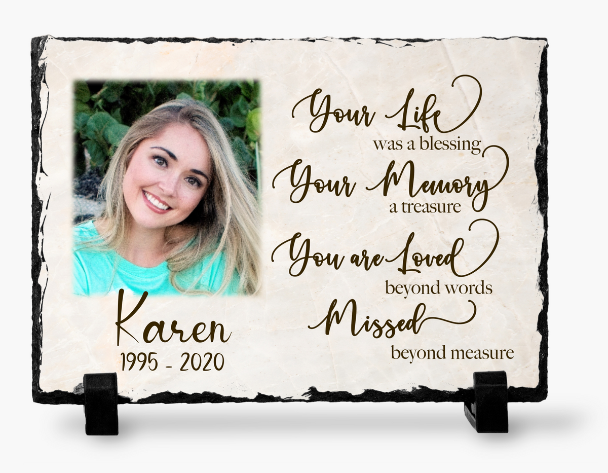 Cream marble-look Your Life, Your Memory memorial photo slate with a woman's portrait, personalized name and dates, brown tribute wording and black stands.