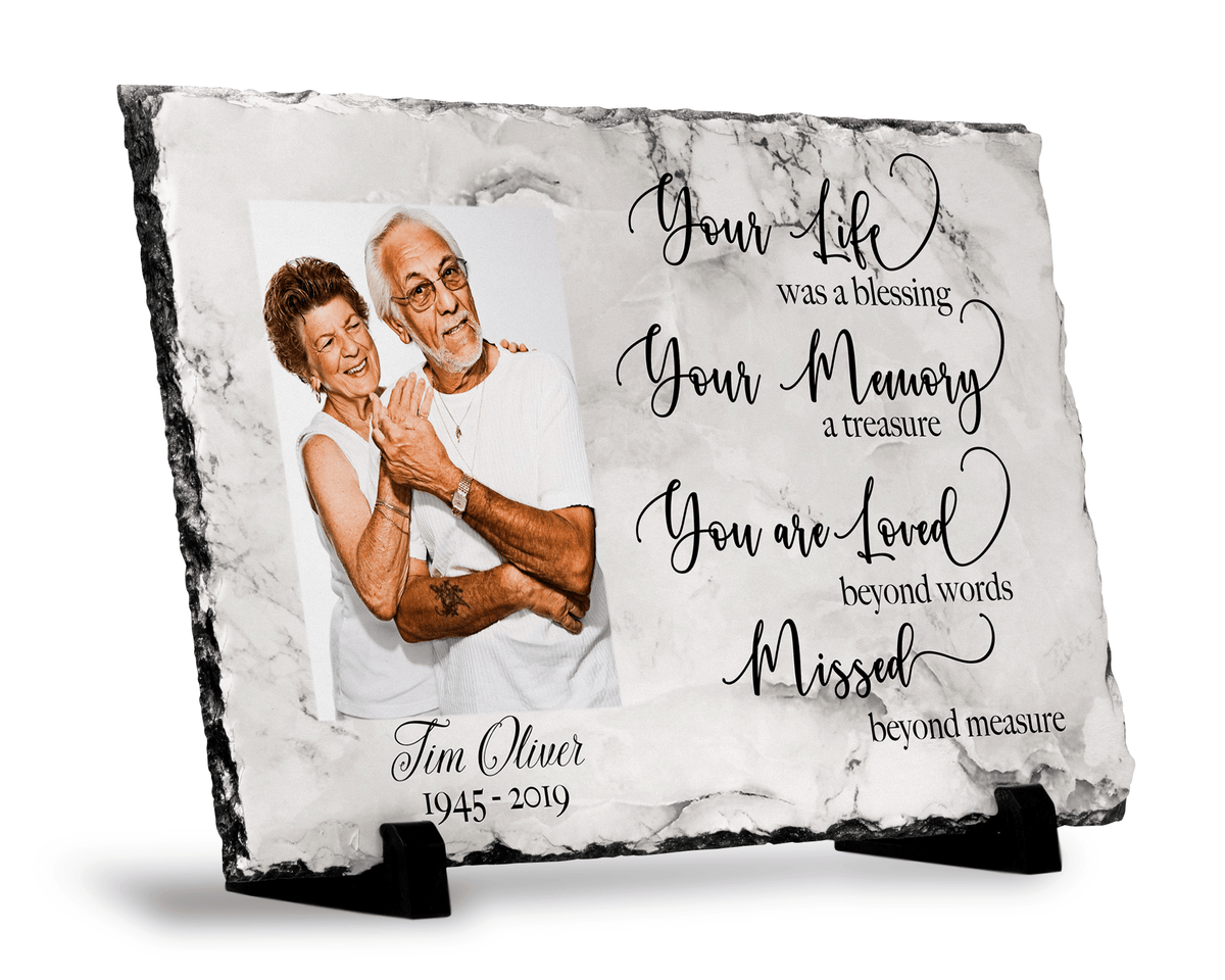 Angled view of a Your Life Was a Blessing photo slate with a printed marble-look design on black stands