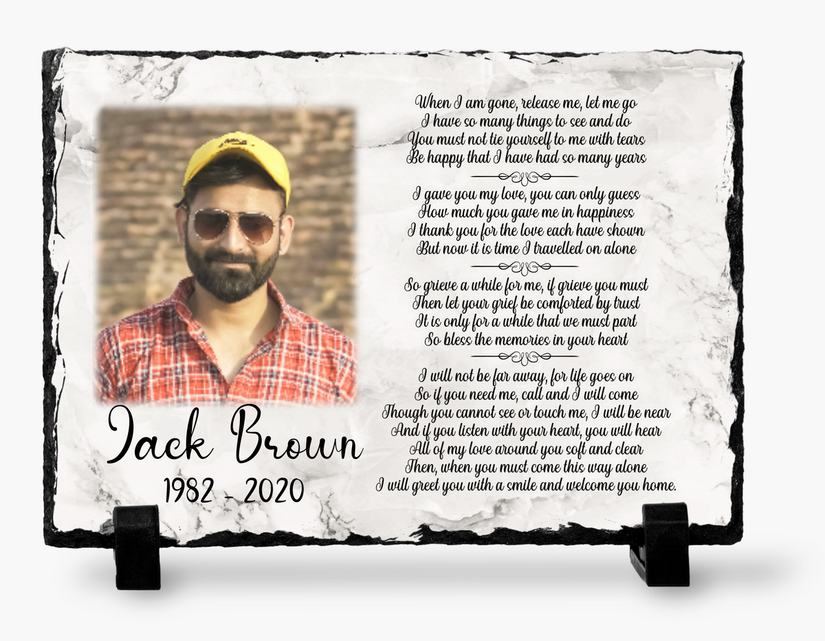 White marble-look When I Am Gone Release Me photo slate with a man wearing a cap and sunglasses, poem, name, dates and black display stands.